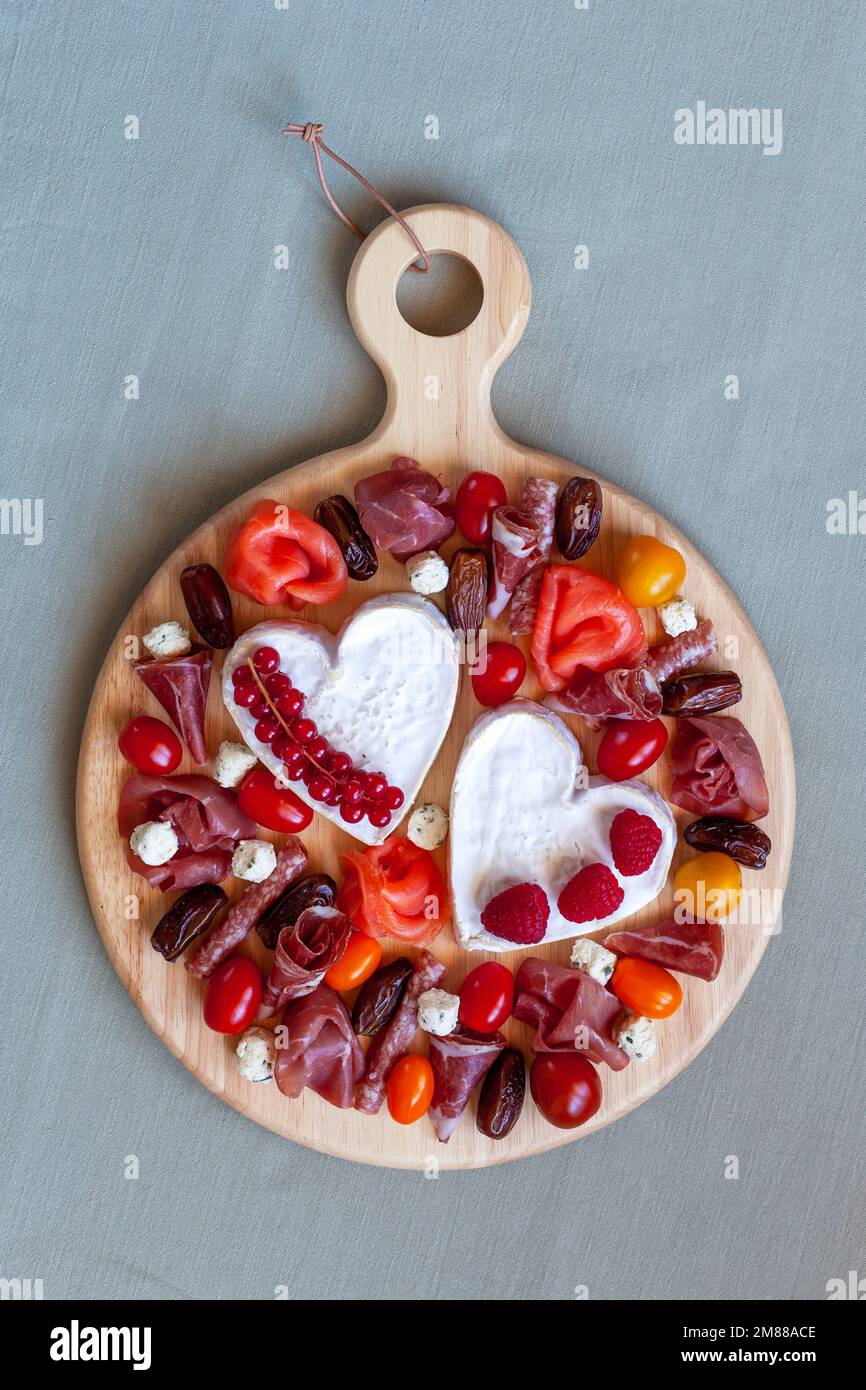 Valentine Day cheese platter with heart shape cheese, delicatessen