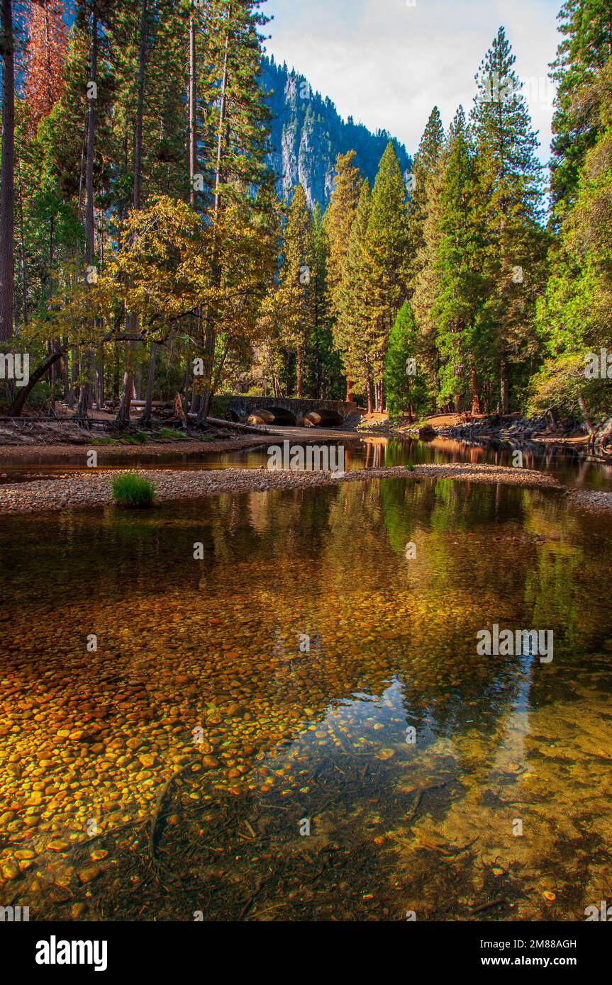 The clear water of the Merced River in Yosemite National Park helps sooth the soul. Stock Photo