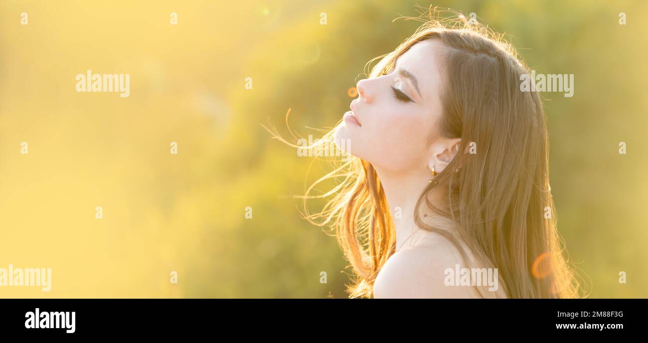 Spring woman on sunlight romantic portrait, sensual sunny face. Banner