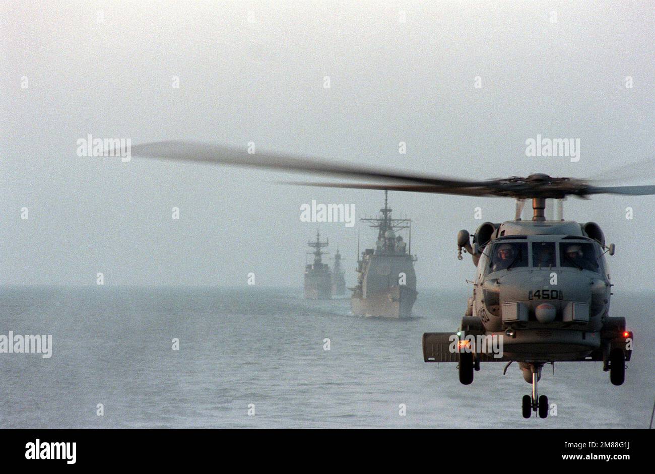 An SH-60B Seahawk helicopter conducts anti-submarine warfare operations ...