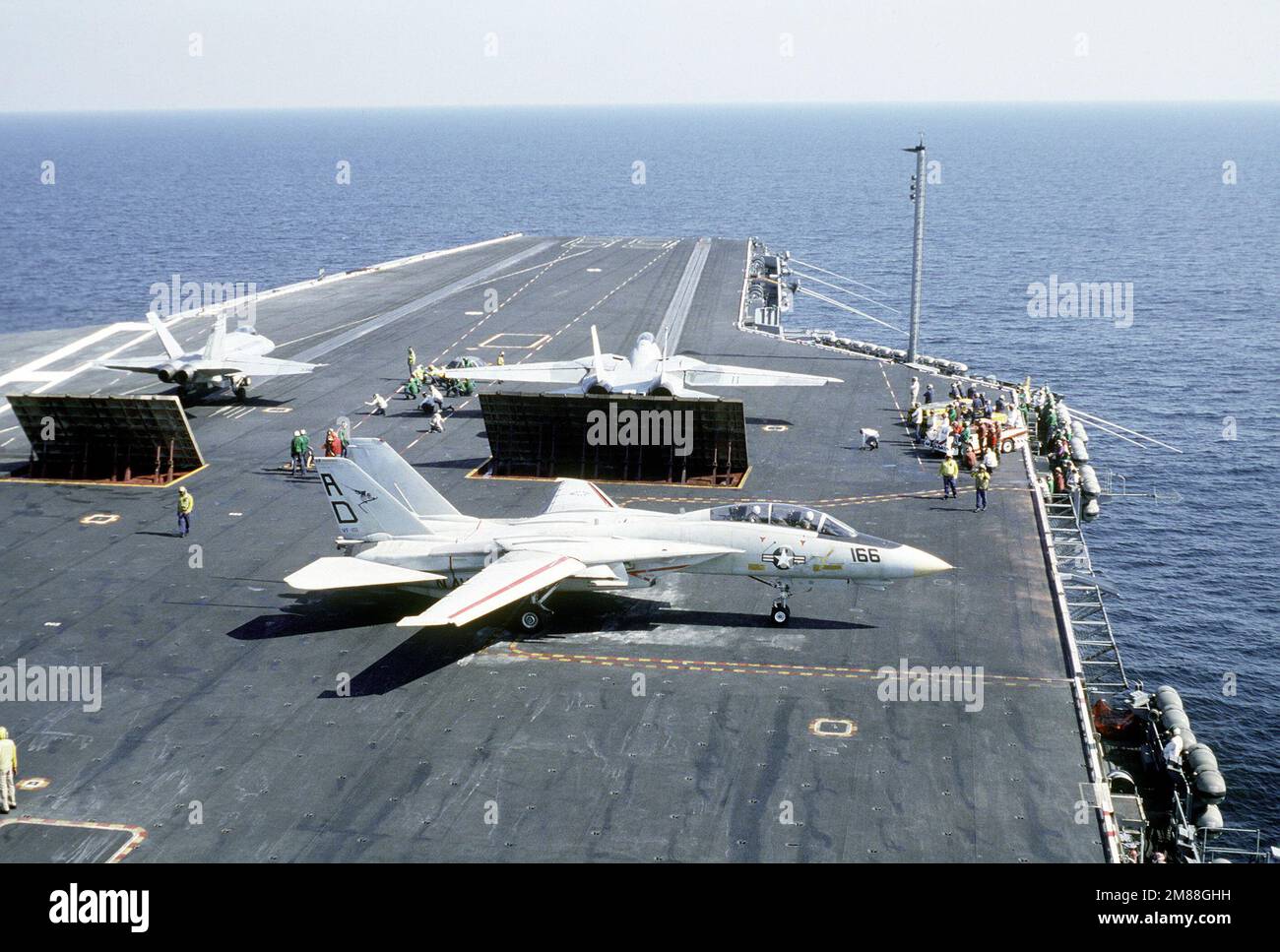 A Fighter Squadron 101 (VF-101) F-14A Tomcat aircraft, right, and a Strike-Fighter Squadron 106 (VFA-106) F/A-18 Hornet aircraft, left, prepare to be launched from the nuclear-powered aircraft carrier USS DWIGHT D. EISENHOWER (CVN-69). Another VF-101 F-14A Tomcat aircraft is being maneuvered into position for launching, foreground. Country: Atlantic Ocean (AOC) Stock Photo