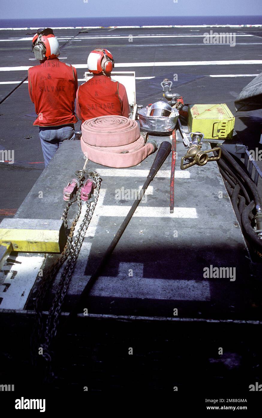 Crash and salvage crew members stand by with a damage control vehicle