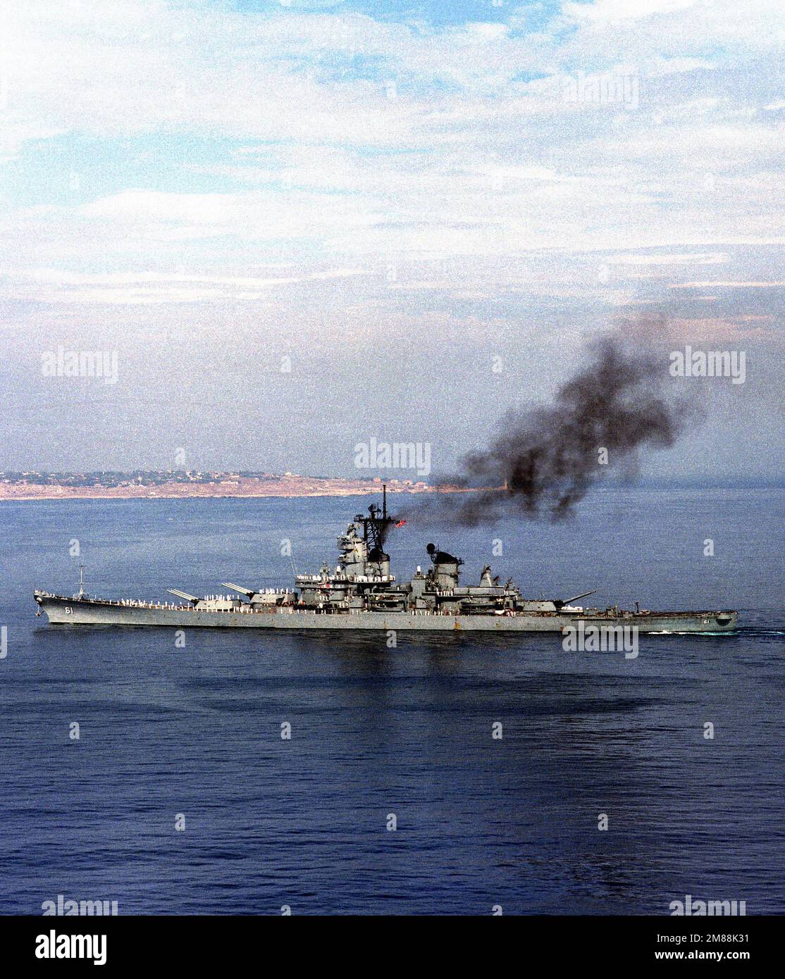 A port beam view of the battleship USS IOWA (BB-61) underway. Base: Augusta Bay Country: Sicily (SIC) Stock Photo
