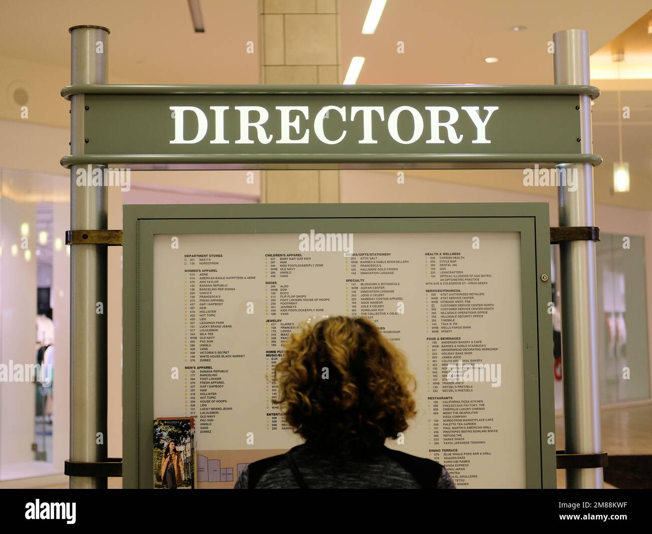 Woman's head reading store directory at Hillsdale Mall in San Mateo, California, USA; generic listing at a shopping center with store names, locations Stock Photo