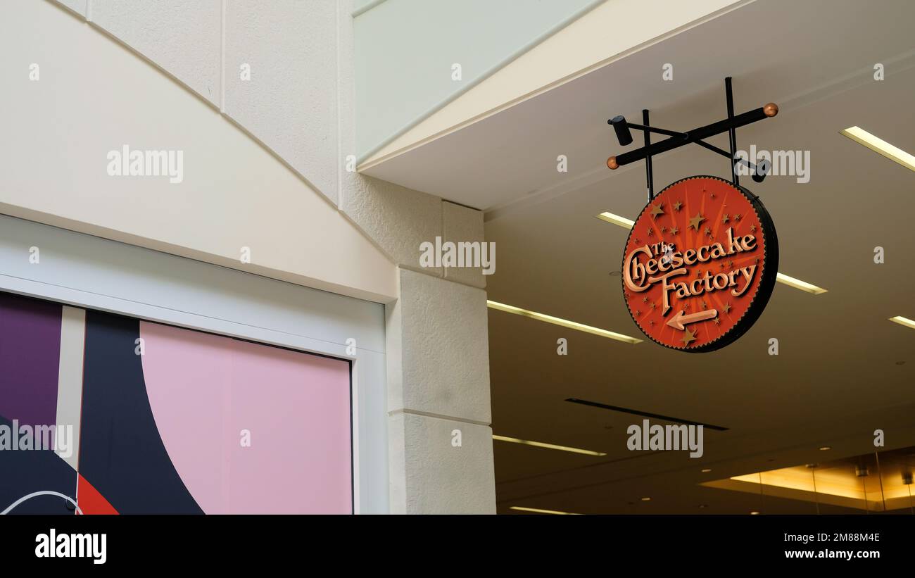 Sign pointing to entrance of The Cheesecake Factory inside the Hillsdale Mall shopping center in San Mateo, California, USA; American restaurant chain Stock Photo