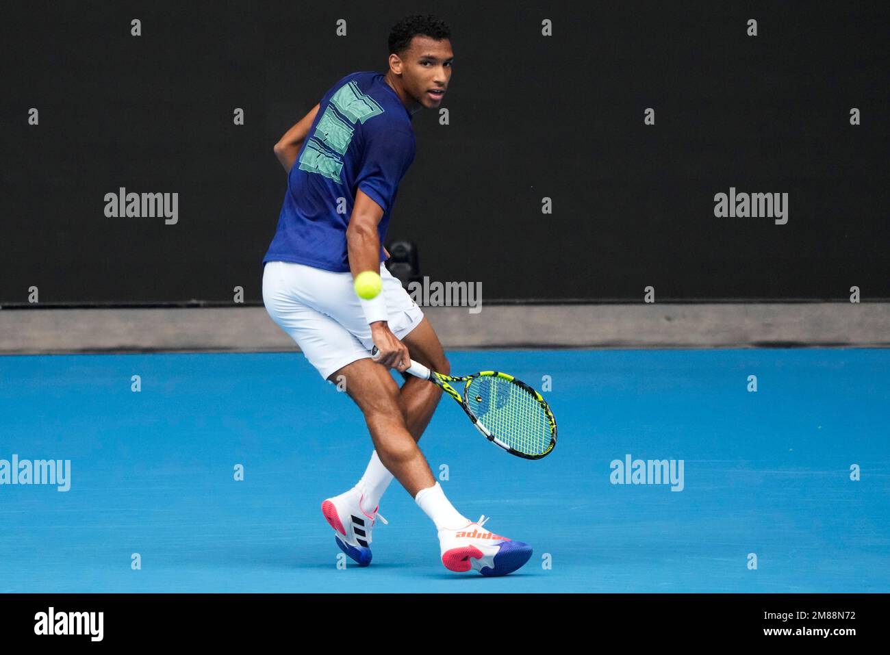 Canadas Felix Auger-Aliassime plays a backhand return to Spains Rafael Nadal during a practice session on Rod Laver Arena ahead of the Australian Open tennis championship in Melbourne, Australia, Friday, Jan