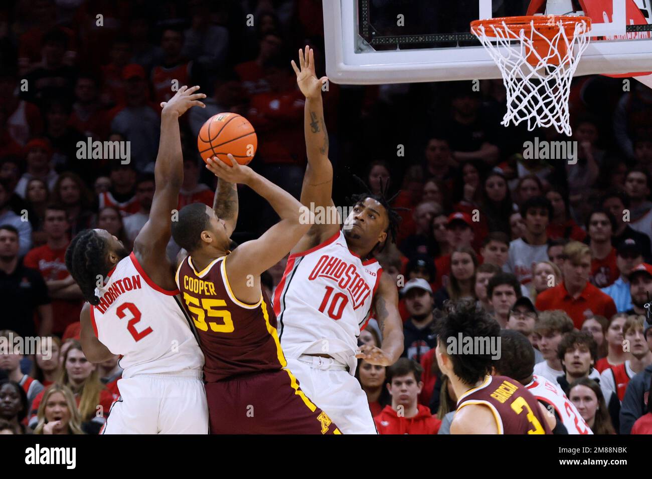 Minnesota's Ta'Lon Cooper (55) shoots from between Ohio State's Bruce ...