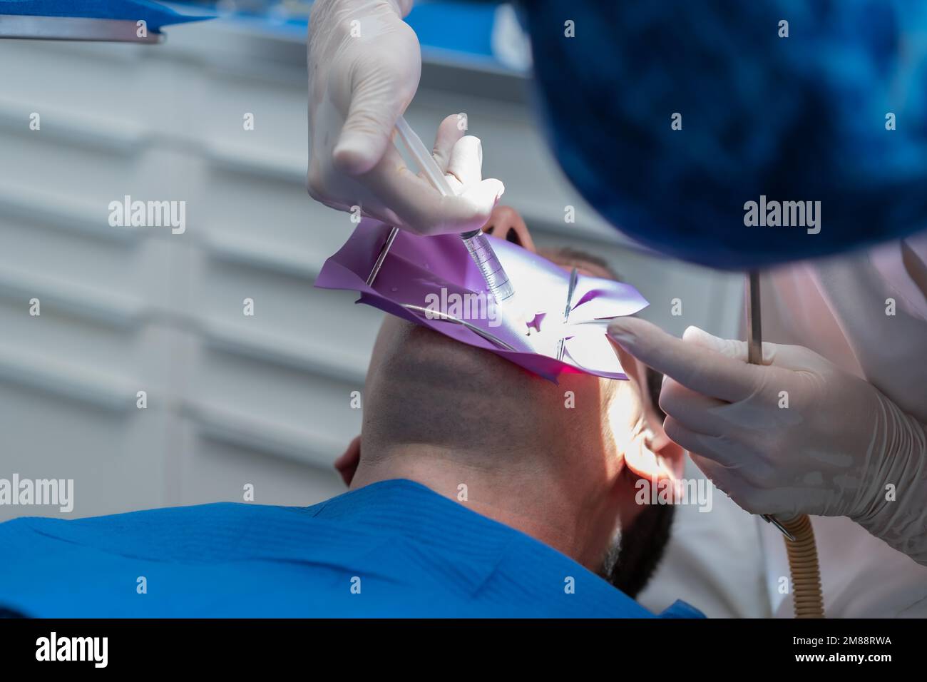 Dental clinic, detail a doctor performing an endodontics to a patient in full operation Stock Photo