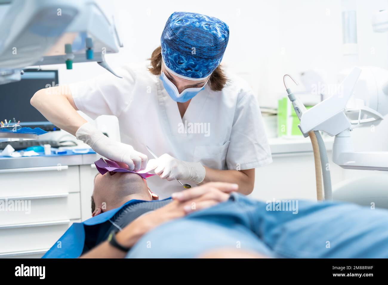 Dental clinic, doctor performing an endodontic operation on a patient Stock Photo
