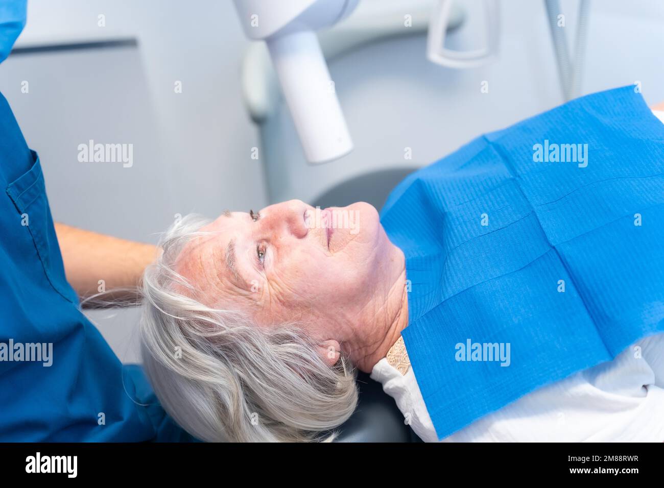 Dental clinic, elderly woman lying at the dentist on denture checkup Stock Photo