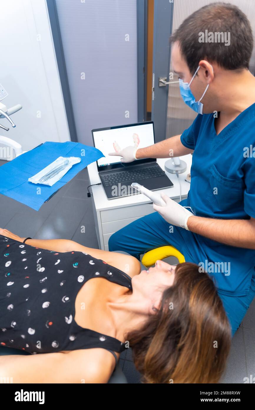 Dental clinic, detail of the dentist performing a 3d scan of the lying patient Stock Photo