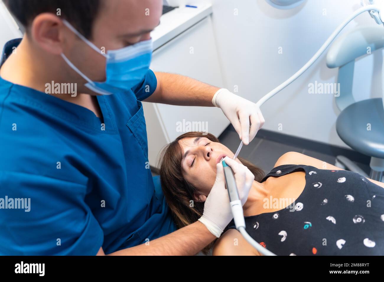 Dental clinic, dentist making a filling to the young patient Stock Photo