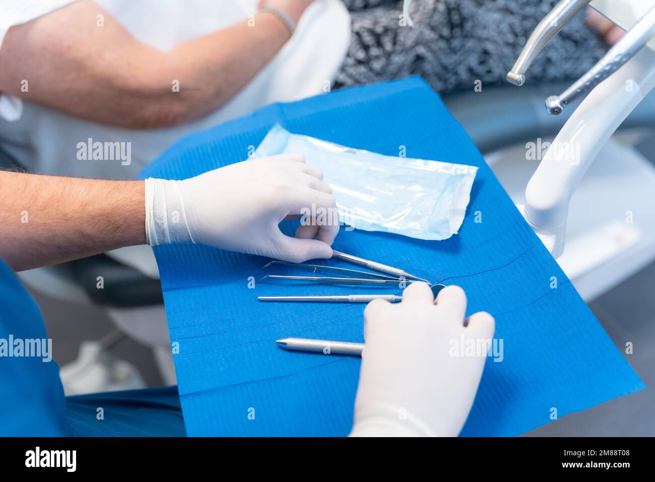 Dental clinic, doctor taking disinfected tools out of the case before the operation Stock Photo