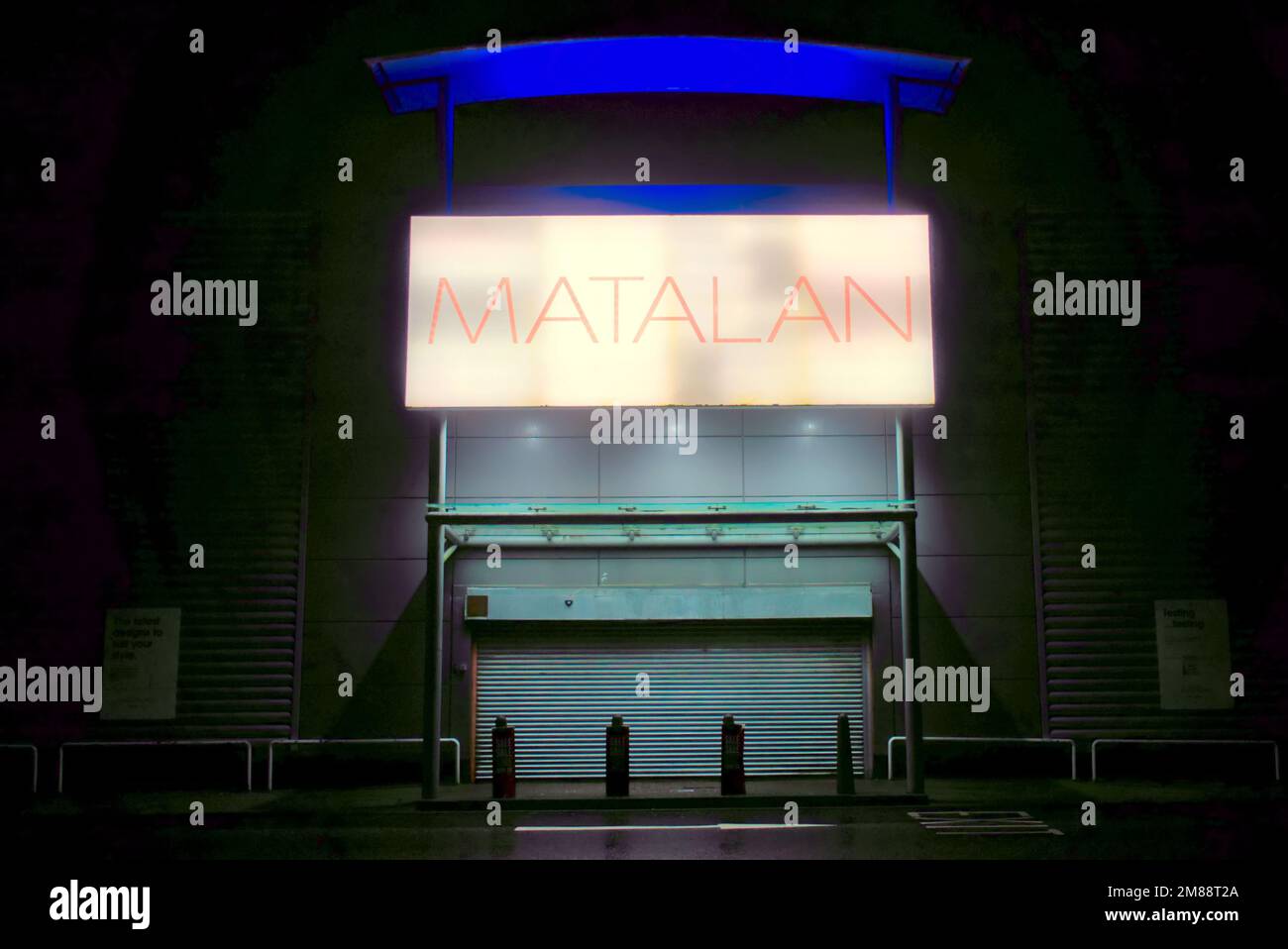 Matalan shop sign above front entrance at night with no people Clyde Retail Park, Livingston Street, Clydebank Stock Photo