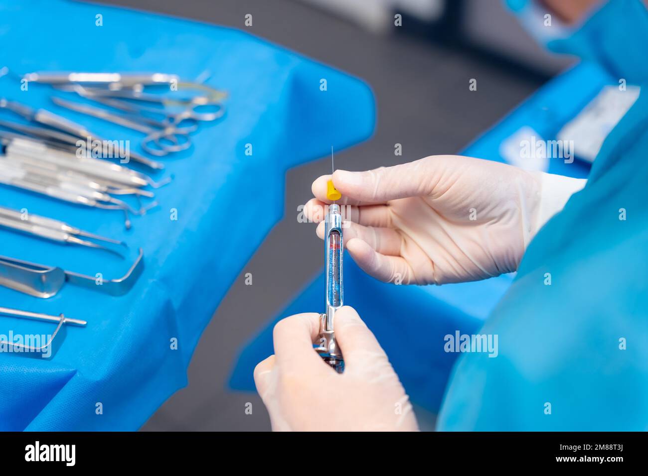 Dental clinic, female dentist doctor preparing anesthesia injection