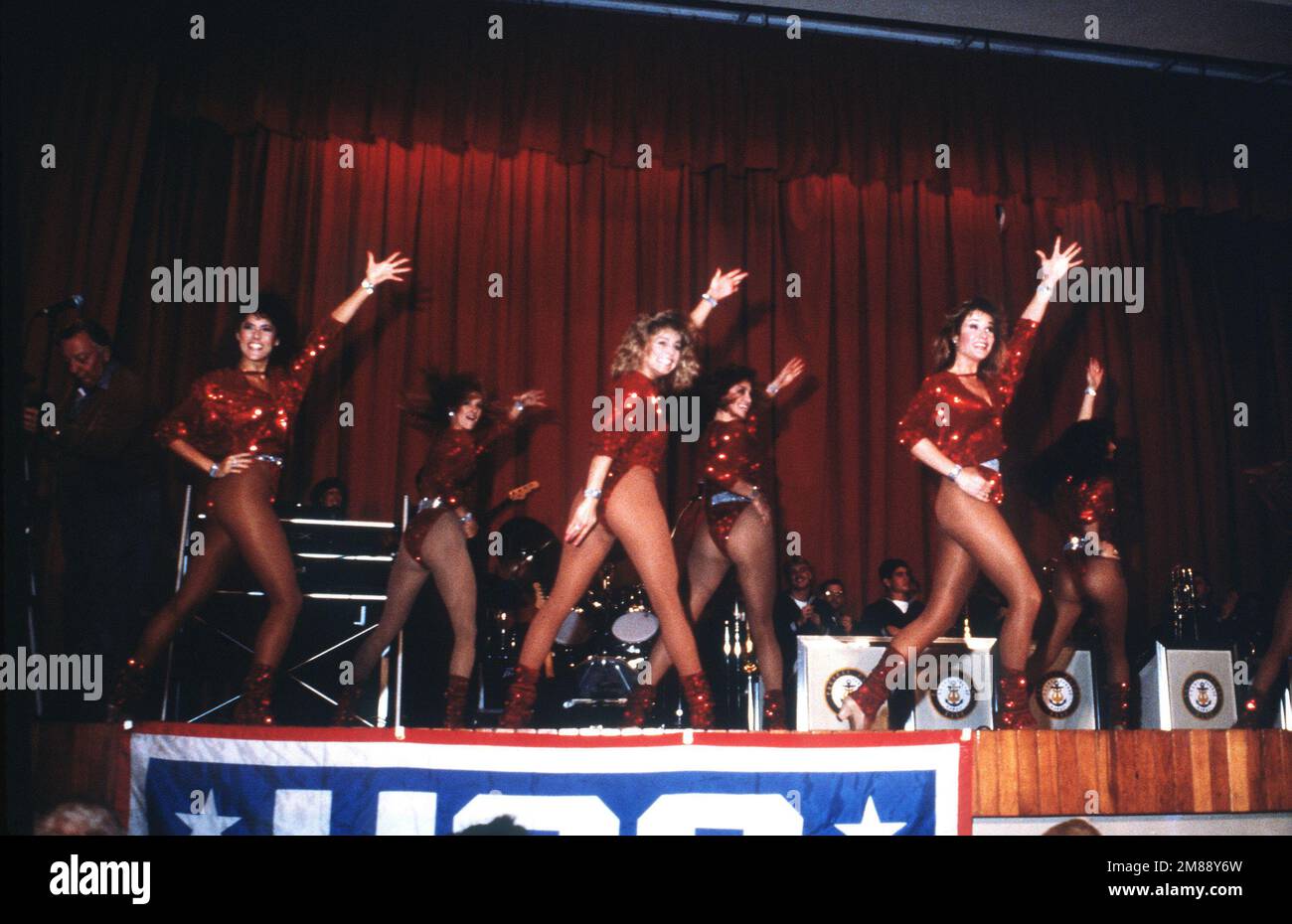 Dancers backed by the Pacific Fleet Band perform at a United Service Organizations (USO) show in the base theater. Base: Naval Station, Rota Country: Spain (ESP) Stock Photo