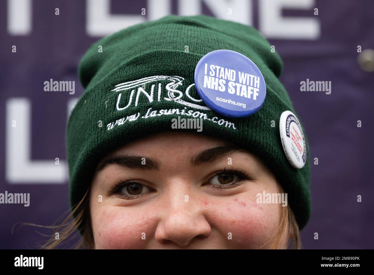 London, UK. 11th Jan, 2023. A female ambulance worker wears a woolly hat featuring a ëI stand with NHS Staffí badge outside Waterloo Ambulance Station. Unison members of the LAS will walk out for 12 hours from 11am on Wednesday in a dispute over pay. Credit: SOPA Images Limited/Alamy Live News Stock Photo