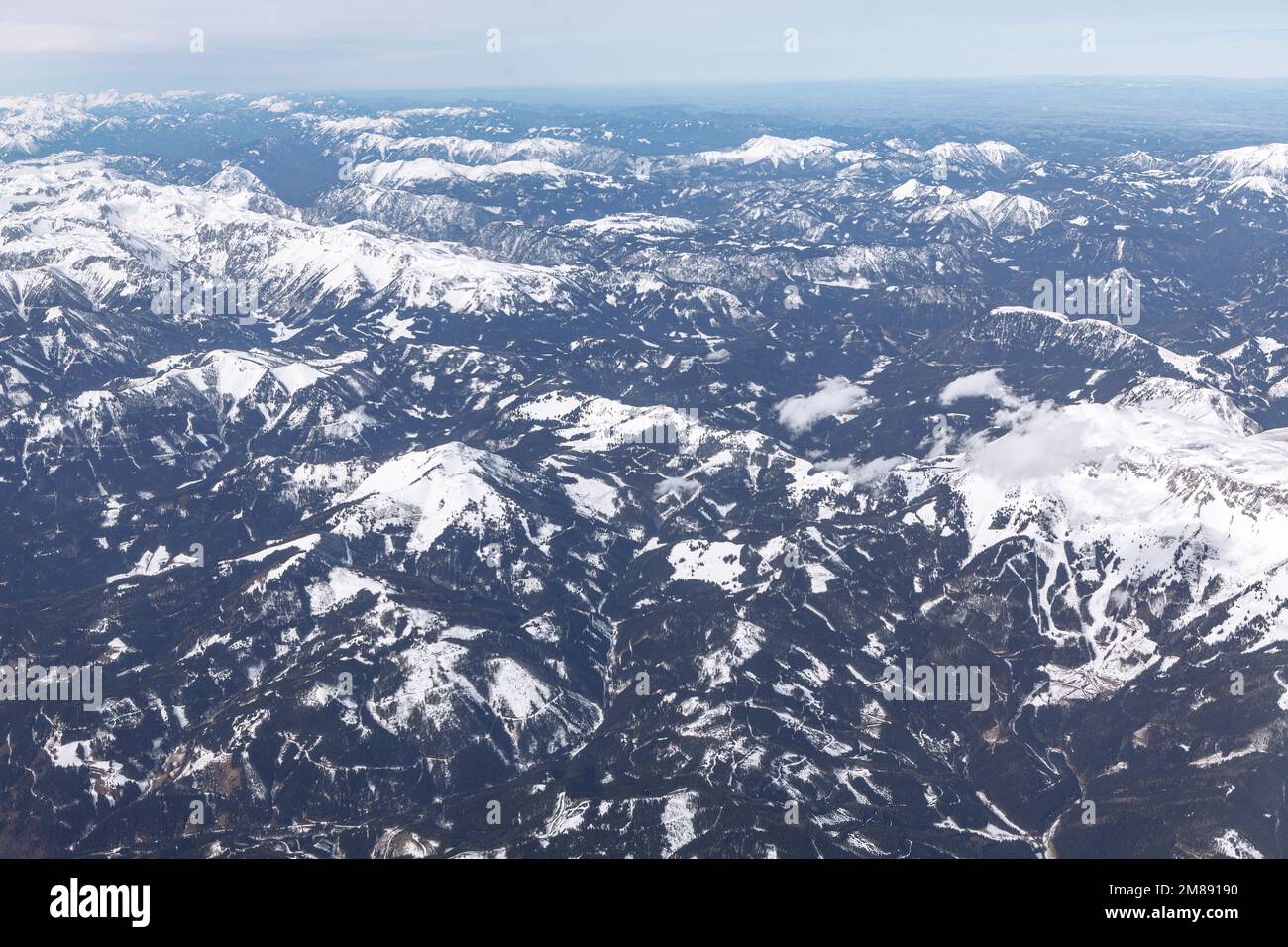 Snow capped mountains aerial view . Flying over the snowy peaks Stock ...