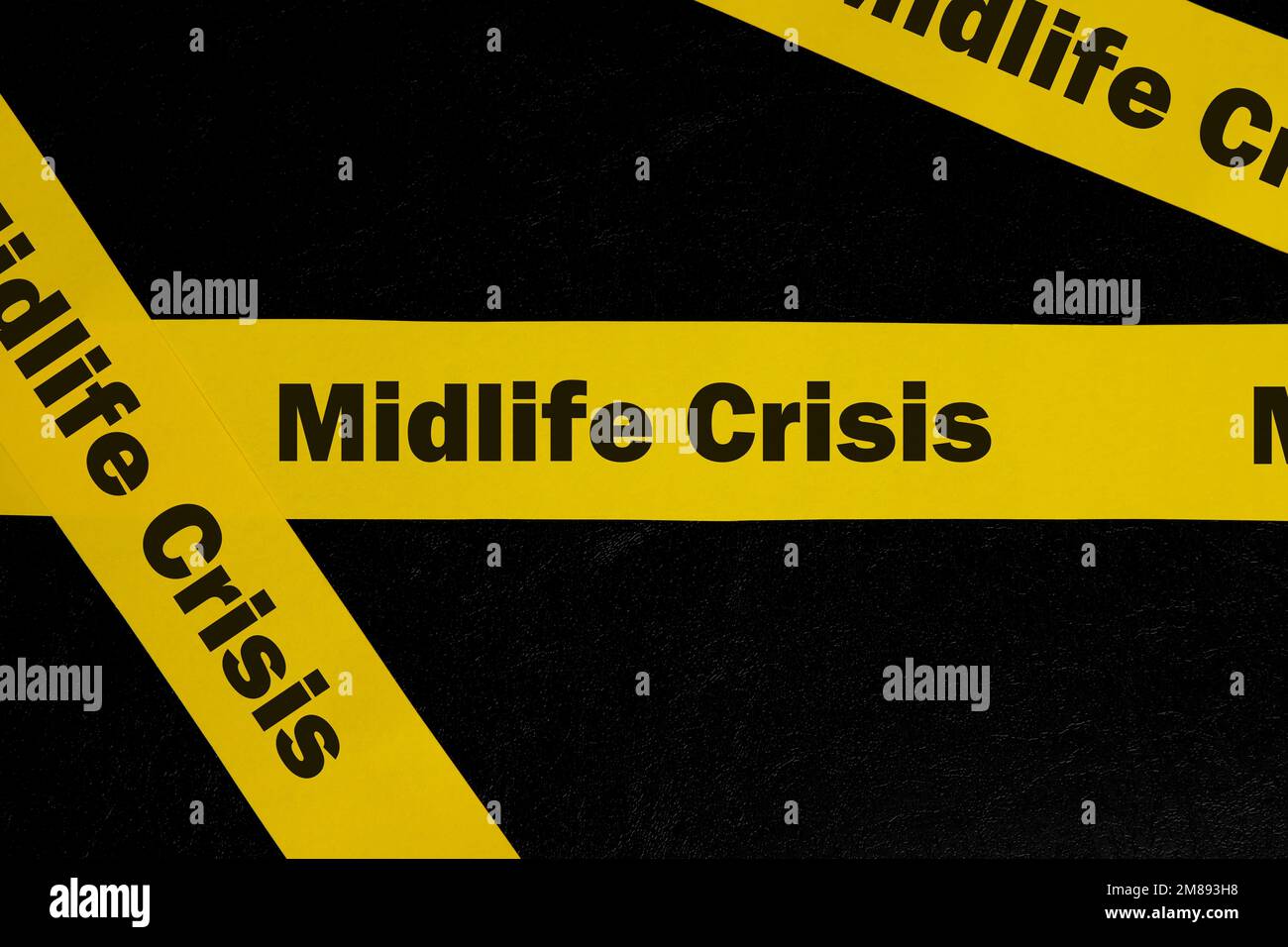 Midlife crisis caution and warning concept. Yellow barricade tape with word midlife crisis in dark black background. Stock Photo