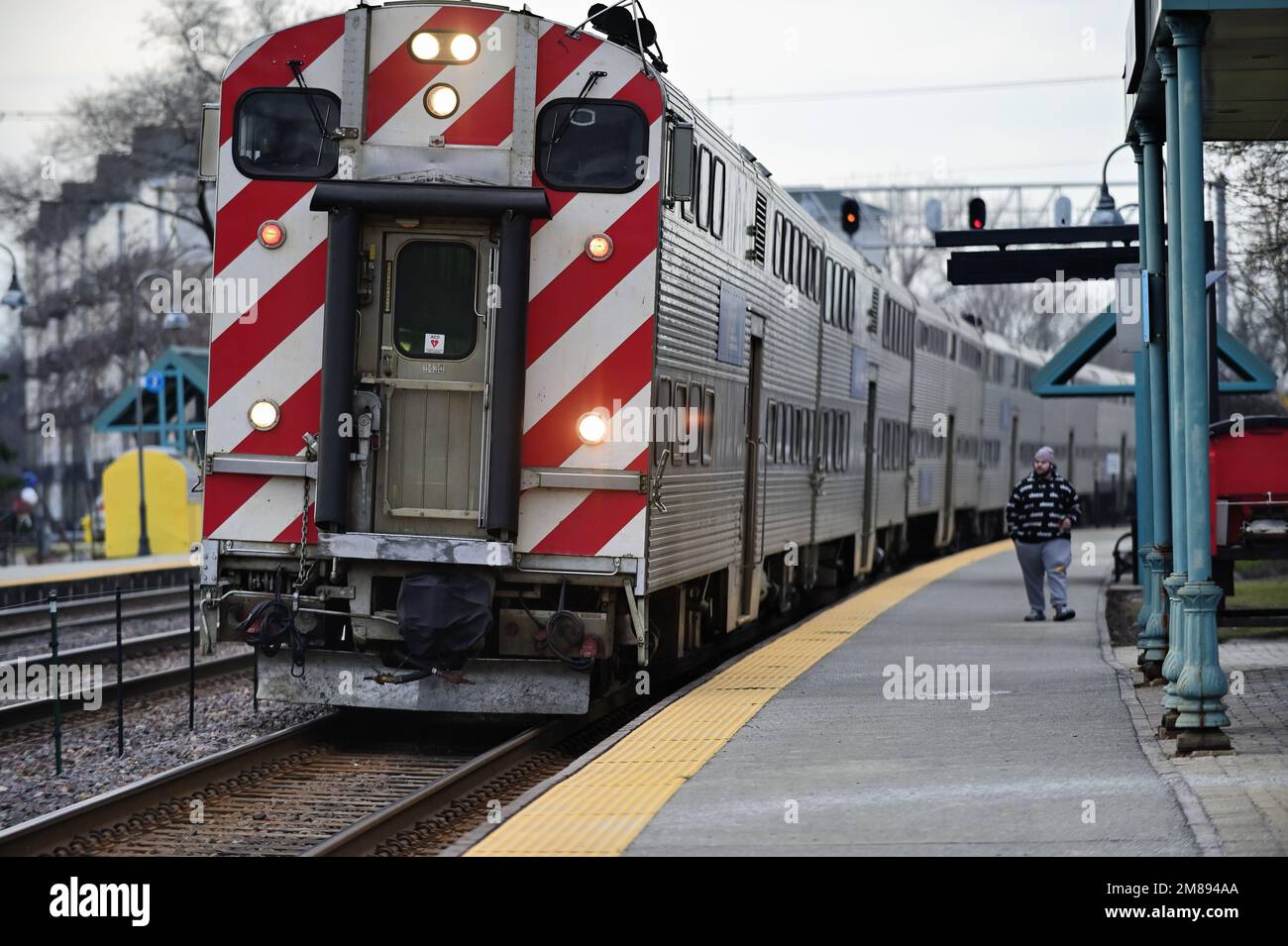 Winfield, Illinois, USA. A lone passenger awaiting the arrival of a Metra commuter train. Stock Photo