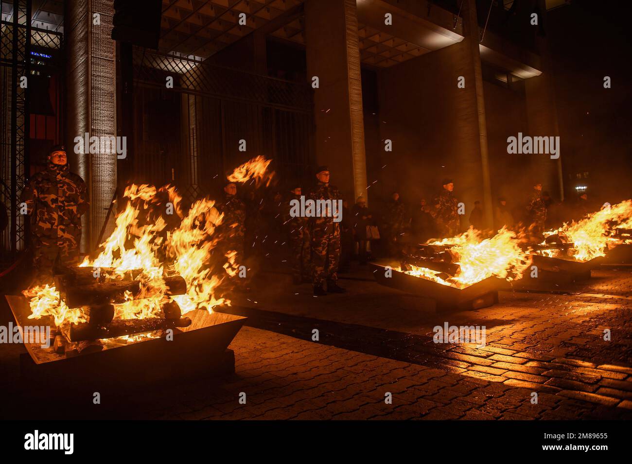 Lithuanian soldiers stand on guard as bonfires burn at the Independence Square near the Lithuanian Parliament building on the eve of the 32nd anniversary of the Day of the Defenders of Freedom 'Battle for the Freedom of Nations' in Vilnius The ceremonial lighting of bonfires took place near the Vilnius TV tower and on the Independence Square on the eve of the day of remembrance for the victims of the January 1991 events, when 14 people died and many were injured during the assault by Soviet troops on the television center in Vilnius. Stock Photo