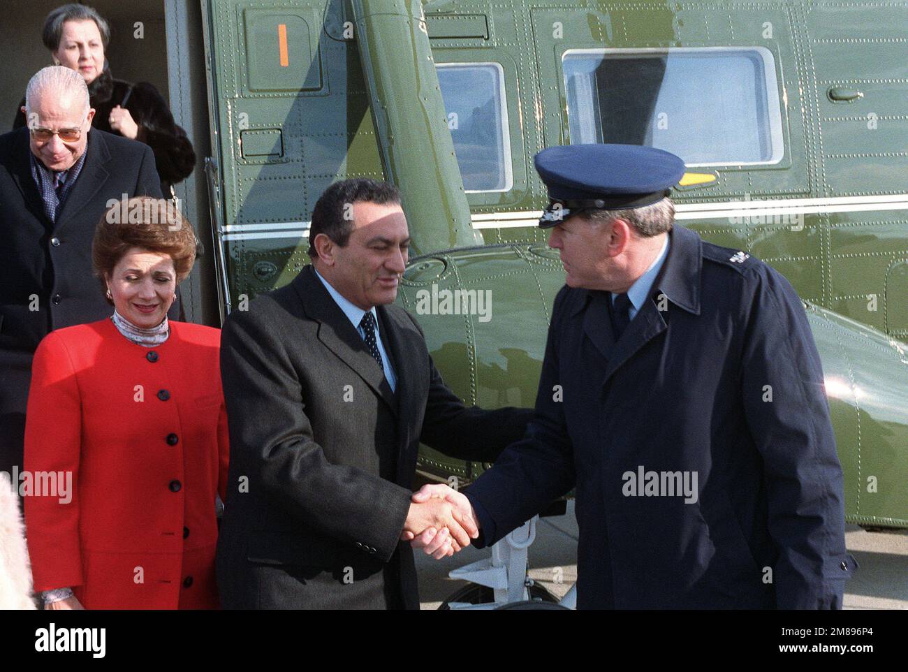 Egyptian President Mohammed Hosni Mubarak and his wife are met by COL John Bacs, Vice Commander, Air Force District of Washington, after disembarking from a Marine Helicopter Squadron 1 (HMX-1) VH-3D Sea King helicopter. The Mubaraks and their party have come to the base to begin their journey back to Egypt following a state visit. Base: Andrews Air Force Base State: Maryland (MD) Country: United States Of America (USA) Stock Photo