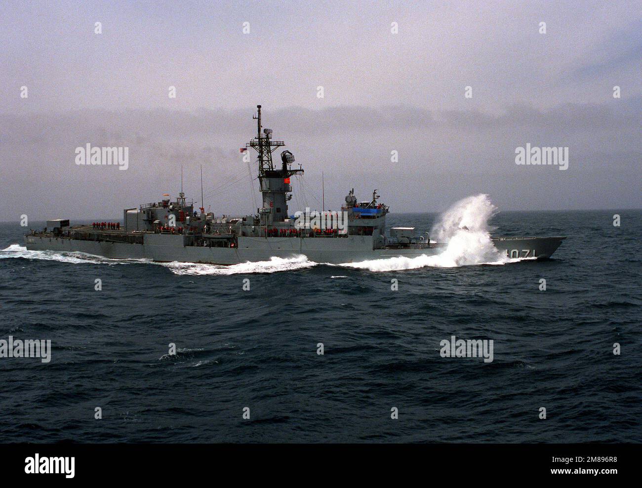 A starboard view of the frigate USS BADGER (FF-1071) underway in rough ...