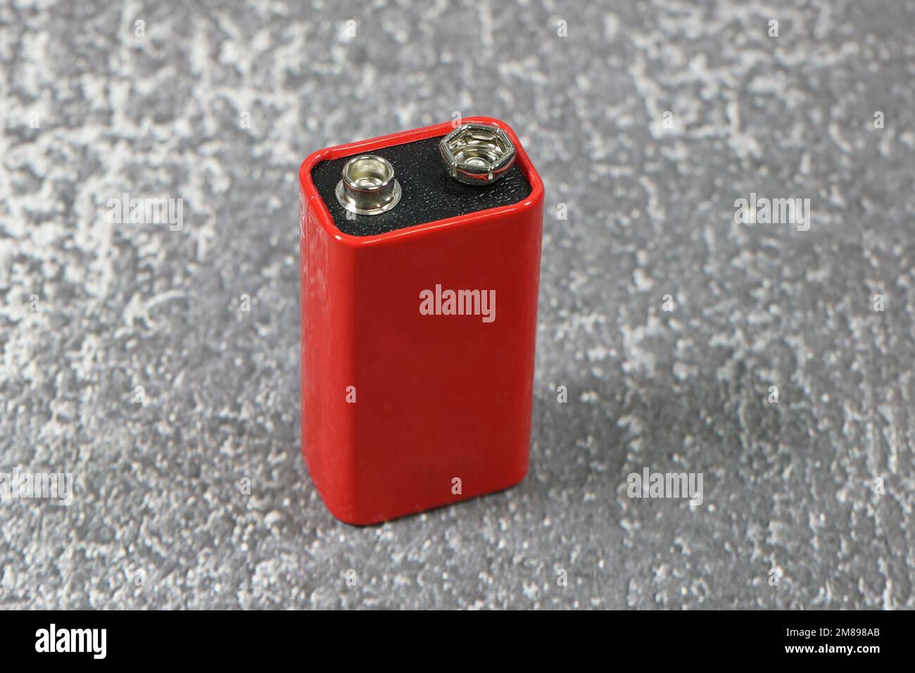 Generic 9V battery, nine volt battery on concrete counter Stock Photo