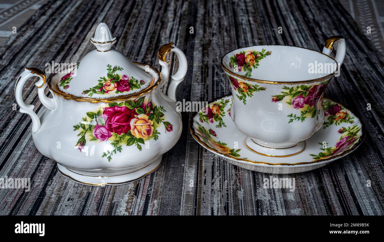 Royal Albert porcelain tableware, sugar bowl and coffee cup. Hand-painted flowers. Can be used to illustrate porcelain dishes in newspapers. Stock Photo