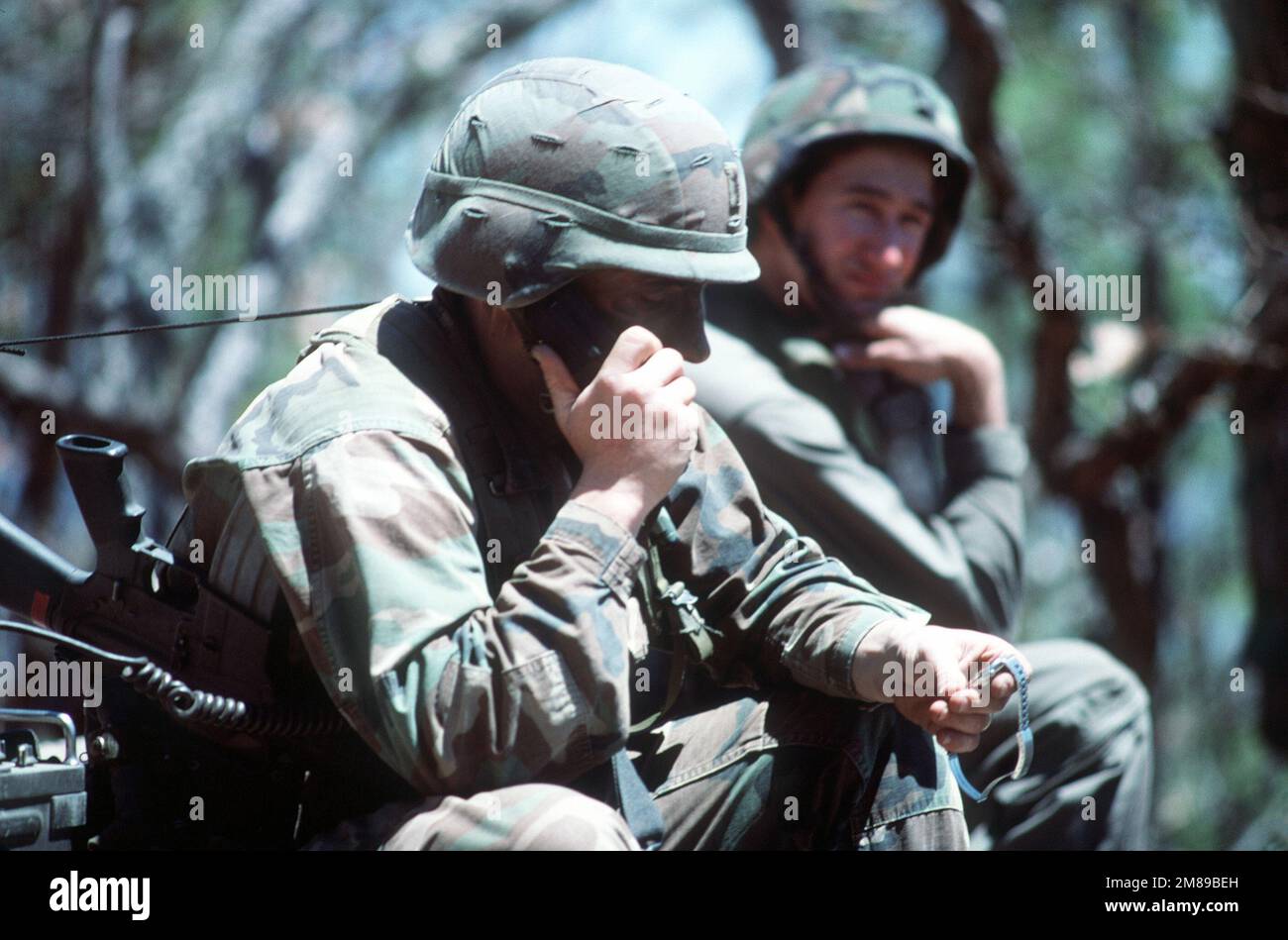 CAPT. David Hollands, a fire support officer for the 1ST Battalion, 17th Air Cavalry Brigade, calls in the AH-1 Cobra helicopter air strike on the Honduran artillery range at Campo Del Balomple. President Ronald Reagan mobilized U.S. exercise task force Dragon/Golden Pheasant, consisting of both the 82nd Airborne Division and the 7th Light Infantry Division, to help discourage Nicaraguan forces from entering Honduras. Subject Operation/Series: DRAGON/GOLDEN PHEASANT Base: Zambrano Country: Honduras (HND) Stock Photo
