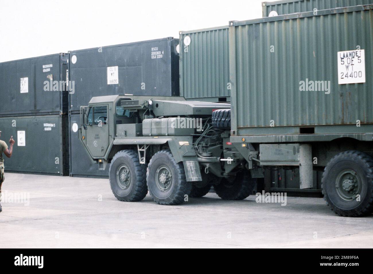 A Mark 48 articulated 8 x 8 vehicle pulls out of a staging area after picking up a container express (CONEX) box during exercise Ocean Venture '88. Subject Operation/Series: OCEAN VENTURE '88 Base: US Naval Station, Roosevelt Road State: Puerto Rico (PR) Country: United States Of America (USA) Stock Photo