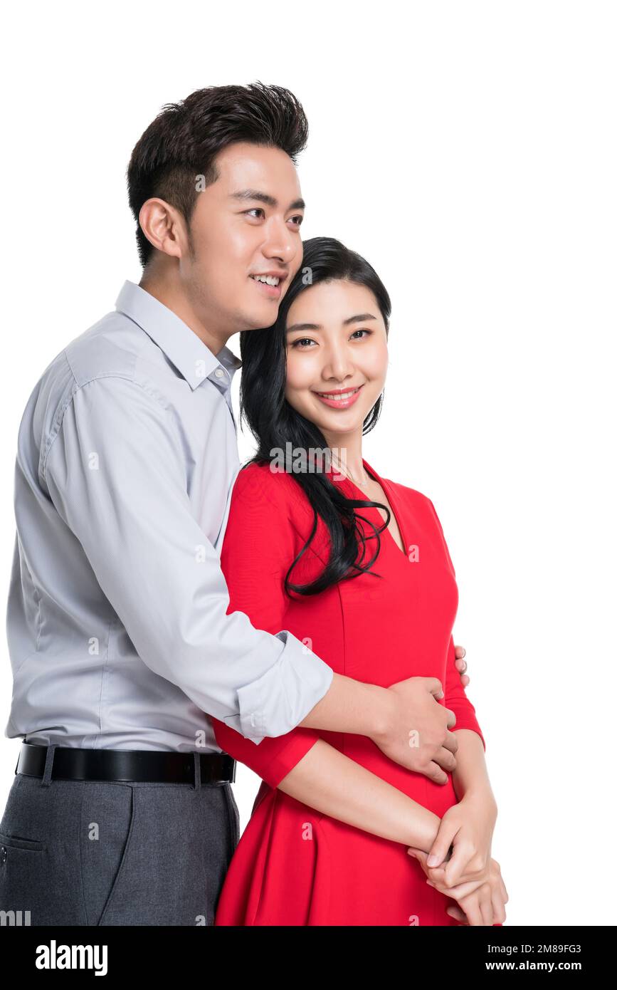 Young lovers behind hug Stock Photo