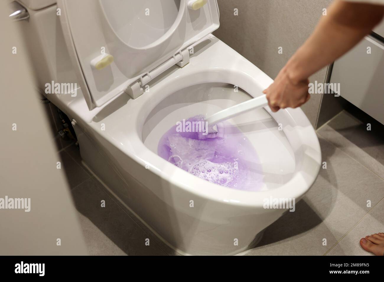 Clean out the toilet with toilet brush, cleaning the bedpan Stock Photo