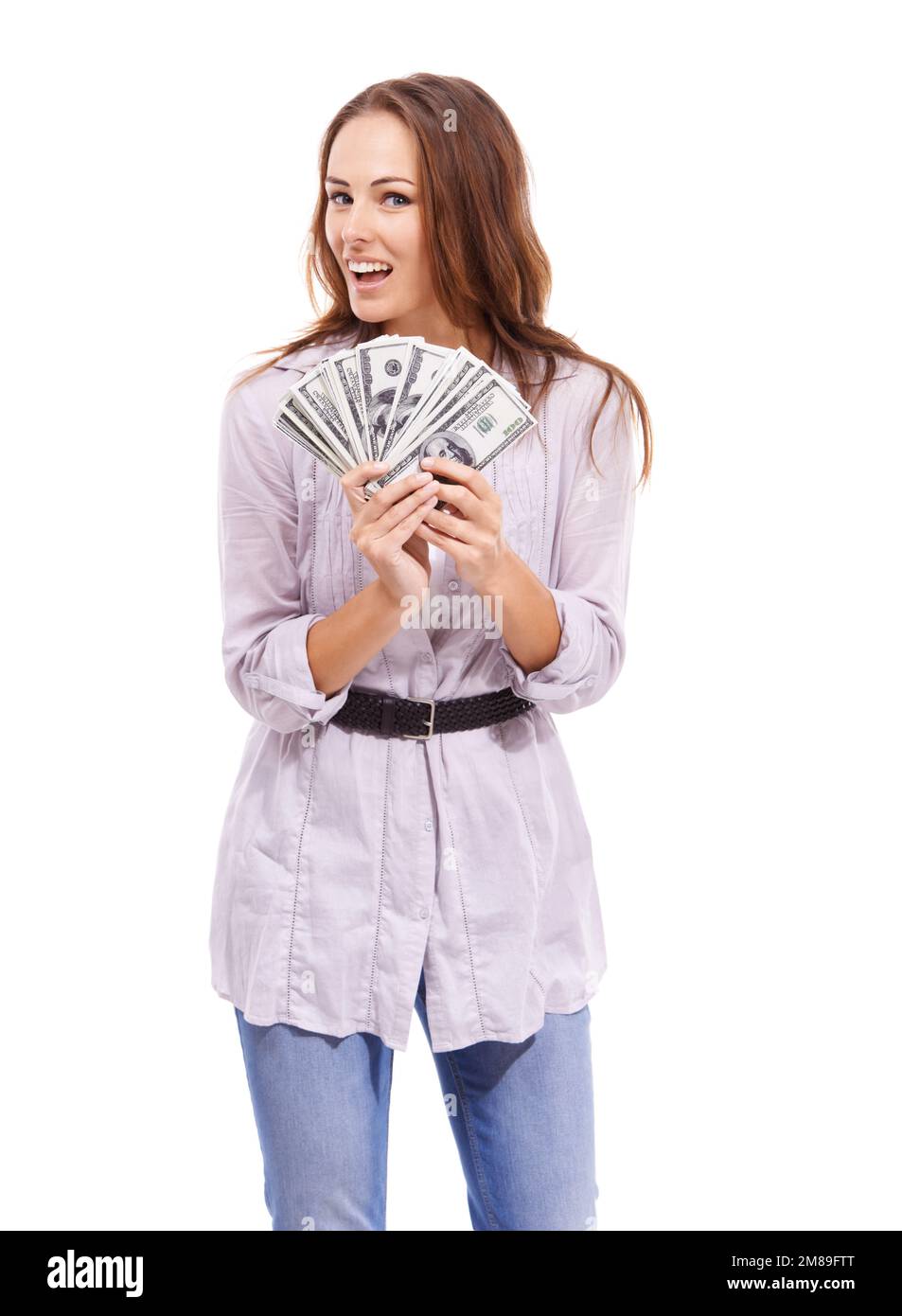 I cant wait to get spending. Casually dressed woman looking excited while holding a wad of cash - isolated on white. Stock Photo
