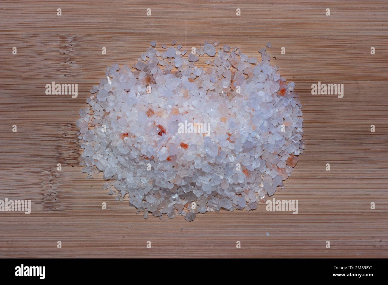 Realistic flatlay of himalayan salt on bamboo cutting or chopping board