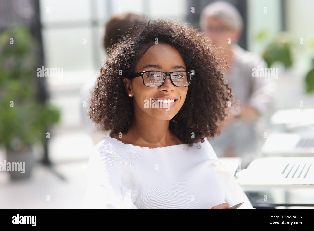 young attractive african american woman in the office Stock Photo - Alamy