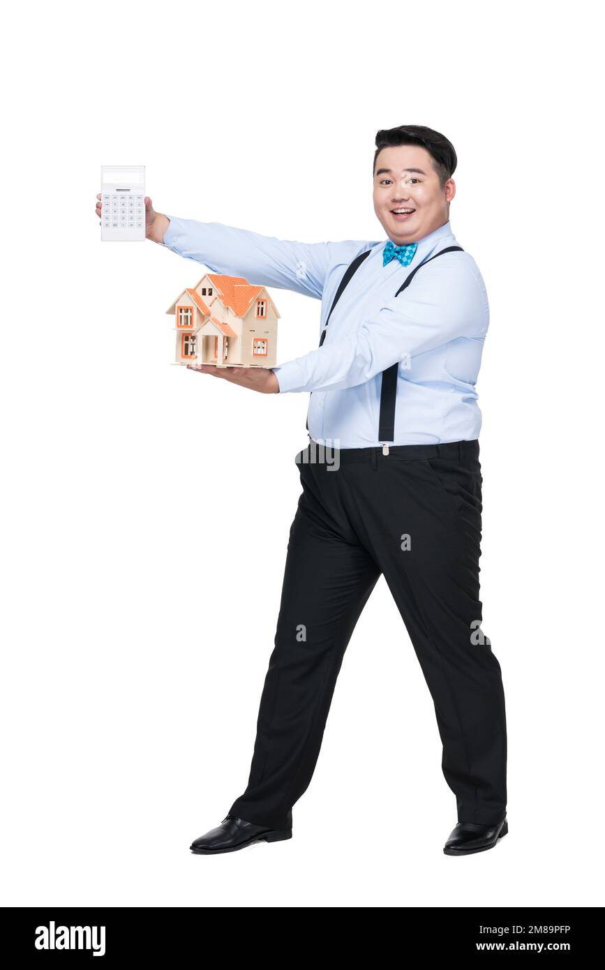 With a calculator and house model fat young men Stock Photo - Alamy
