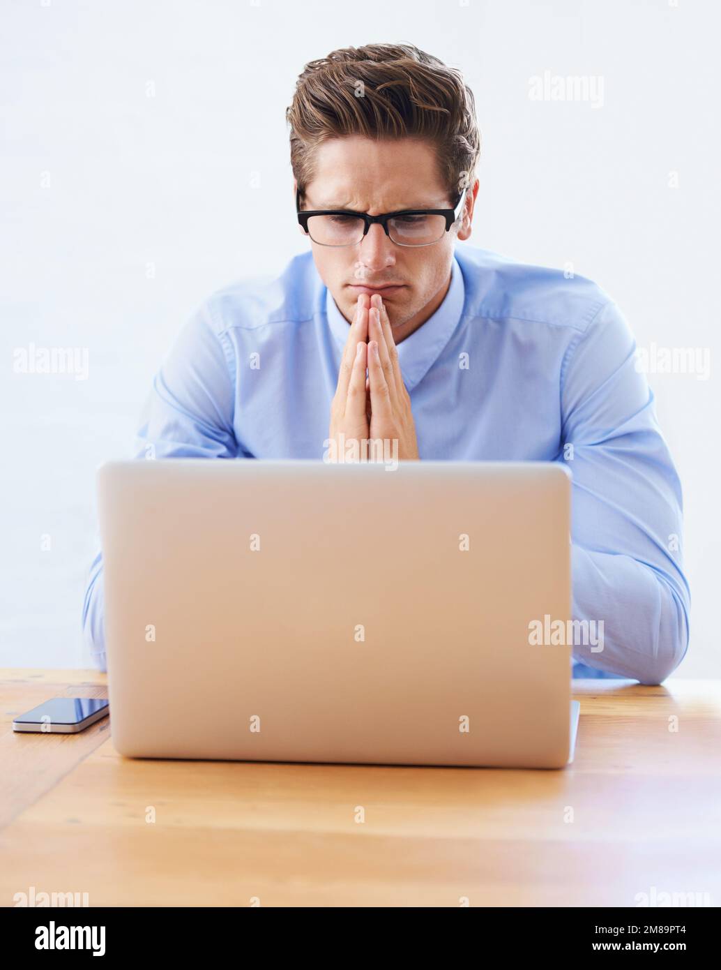 Overcoming project issues. A handsome young businessman focused on his ...