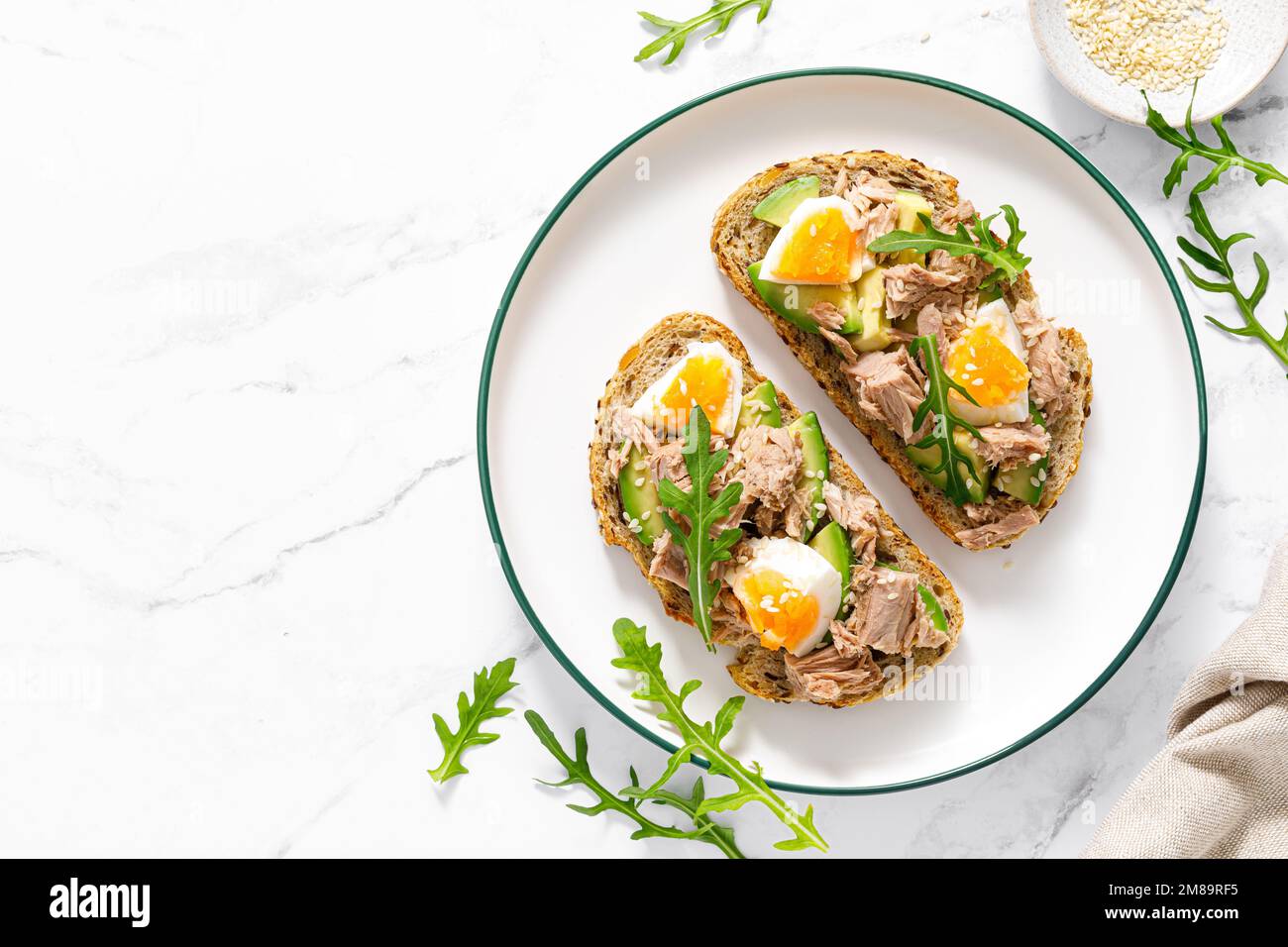 Tuna toast. Open sandwiches with whole grain bread, canned tuna, boiled