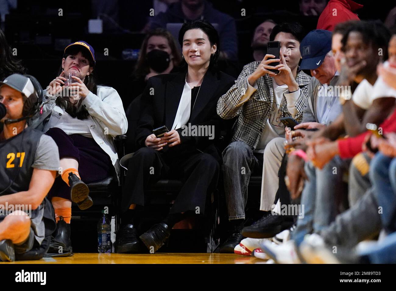 BTS member Suga, center, attends an NBA basketball game between the Los  Angeles Lakers and the Dallas Mavericks Thursday, Jan. 12, 2023, in Los  Angeles. (AP Photo/Jae C. Hong Stock Photo - Alamy