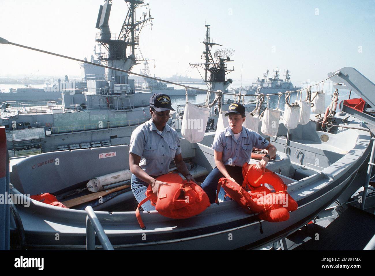 The destroyer tender USS ACADIA (AD-42) lies at anchor with a 