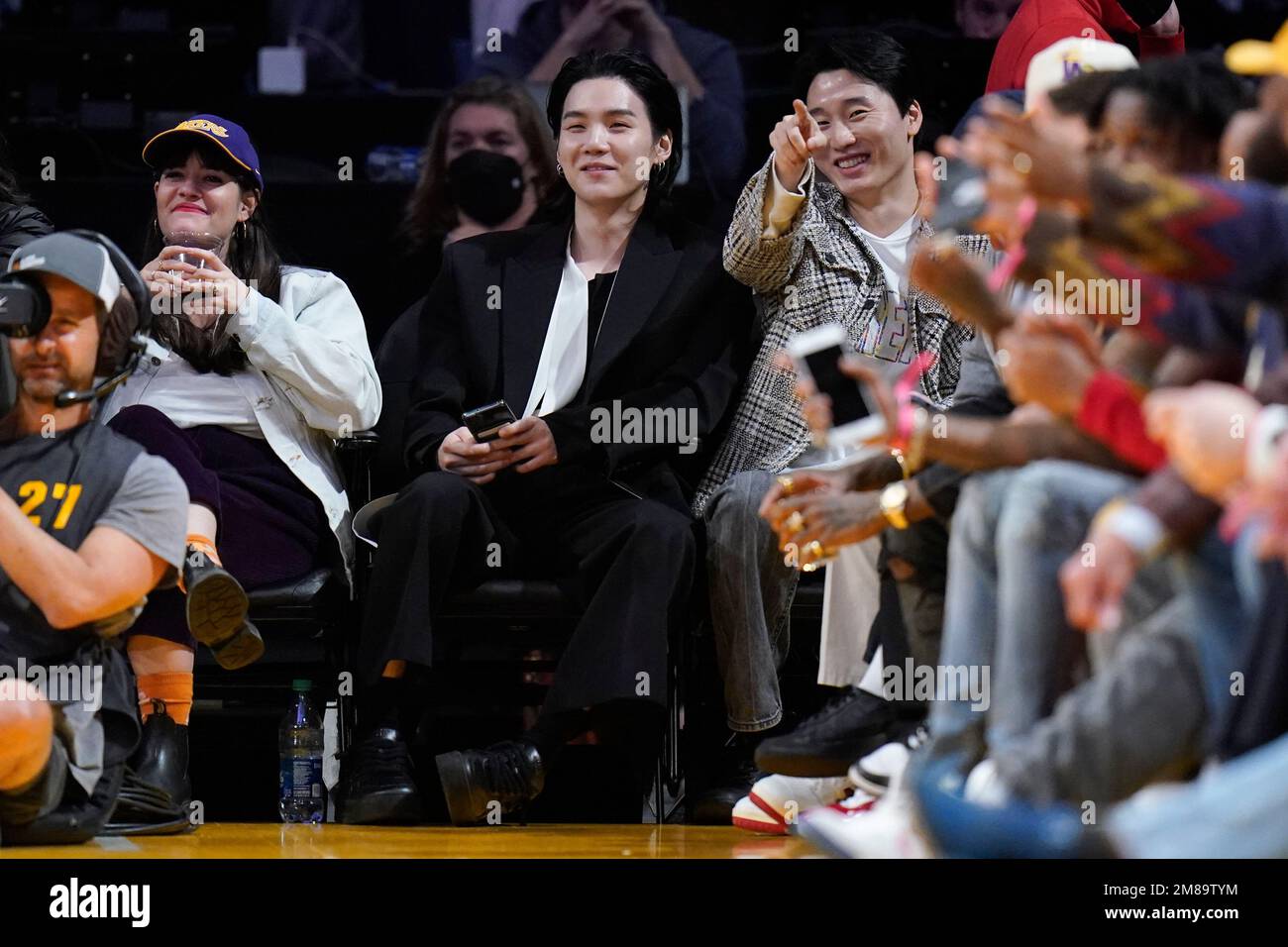 BTS member Suga, center, attends an NBA basketball game between the Los  Angeles Lakers and the Dallas Mavericks Thursday, Jan. 12, 2023, in Los  Angeles. (AP Photo/Jae C. Hong Stock Photo - Alamy