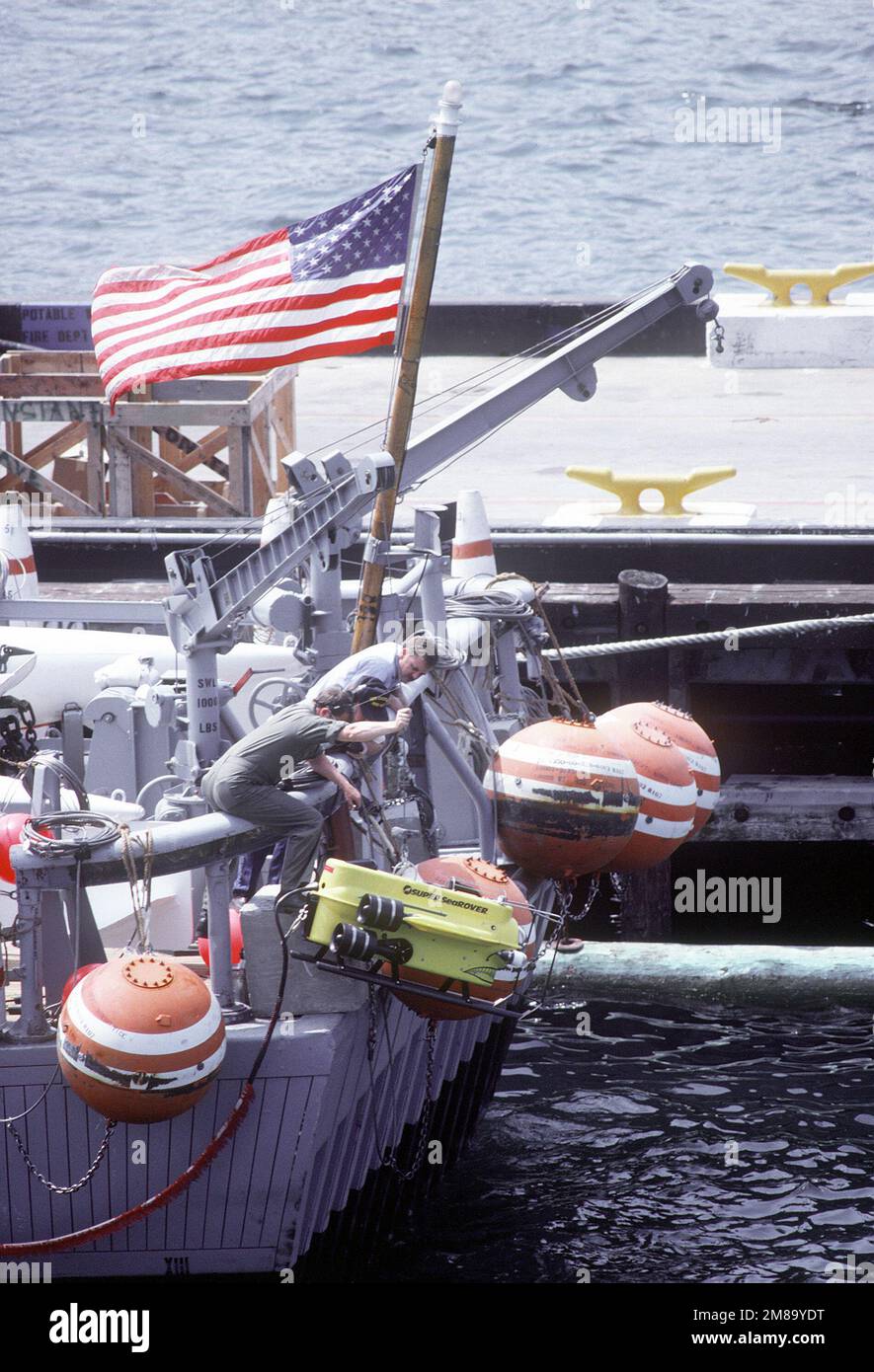 Crewmen on the stern of the ocean minesweeper USS CONSTANT (MS0-427 ...