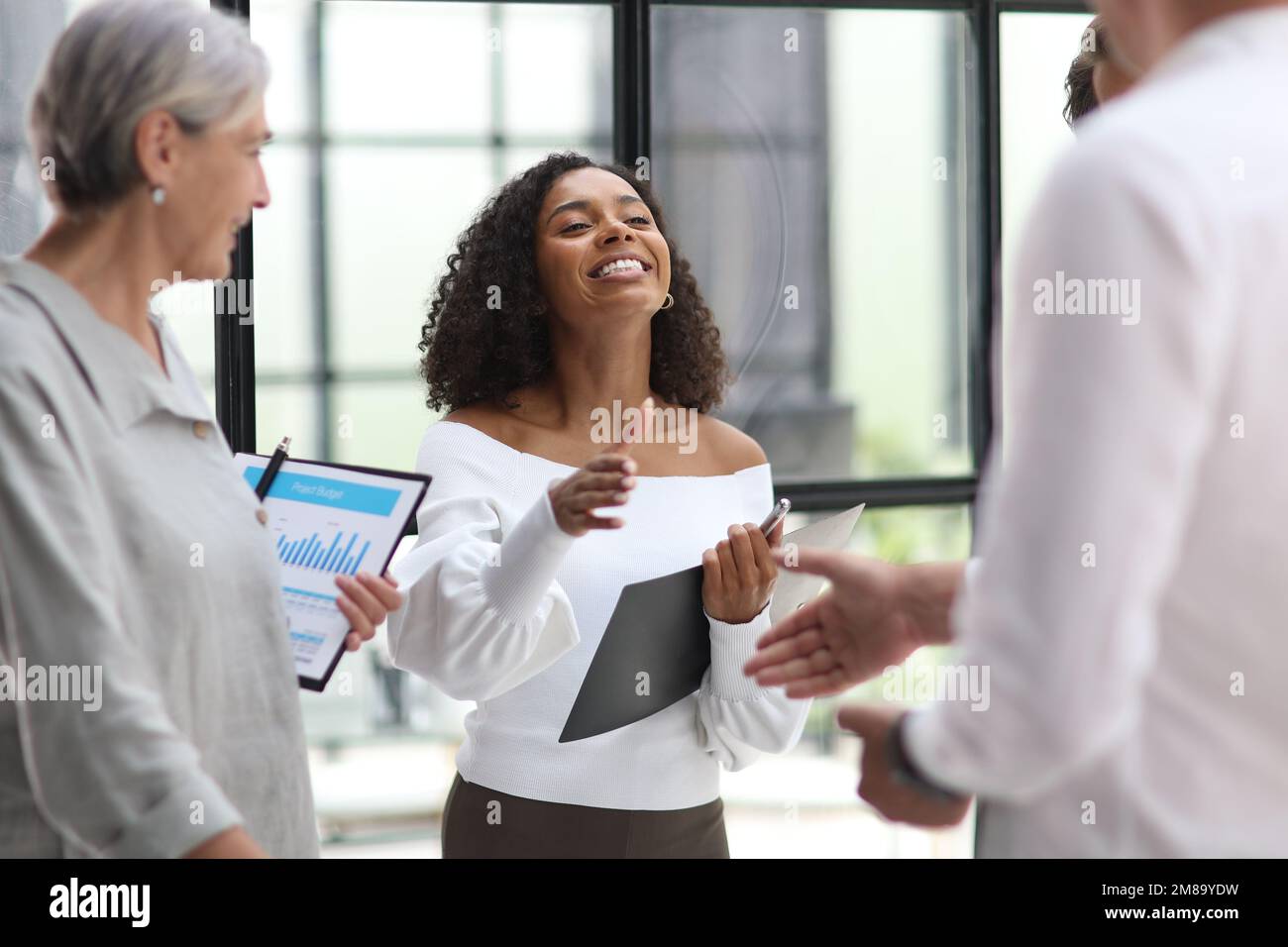 Group of business workers standing together shaking hands at the office Stock Photo