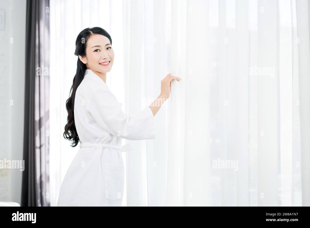 A young woman wearing a bathrobe Stock Photo Alamy