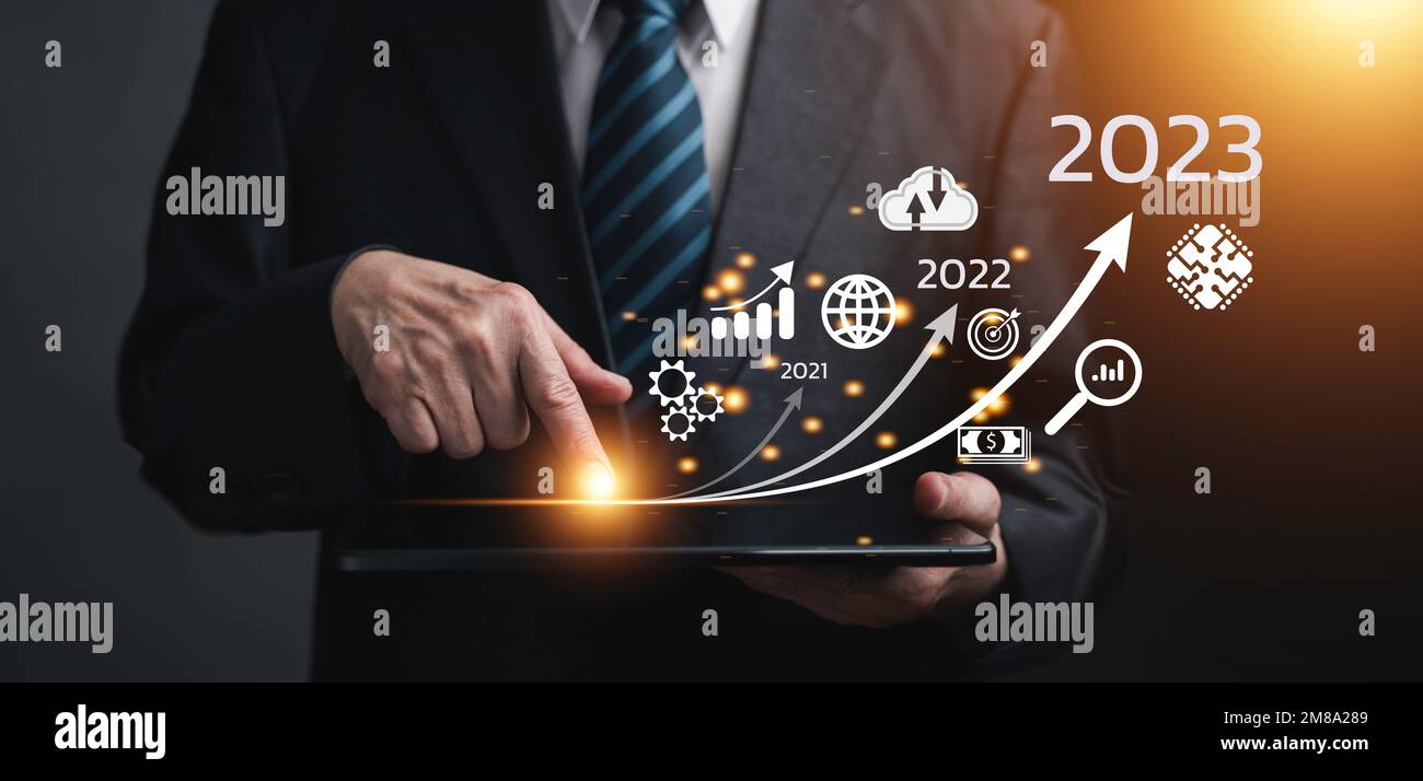 Businessman touching on tablet, line for increasing arrow from 2022 to ...