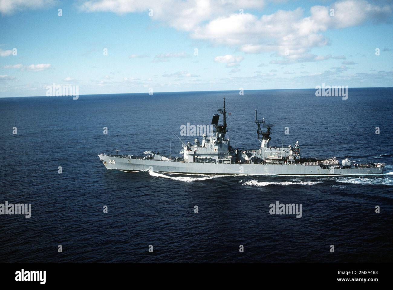 A port view of the guided missile cruiser USS BIDDLE (CG-34) underway ...