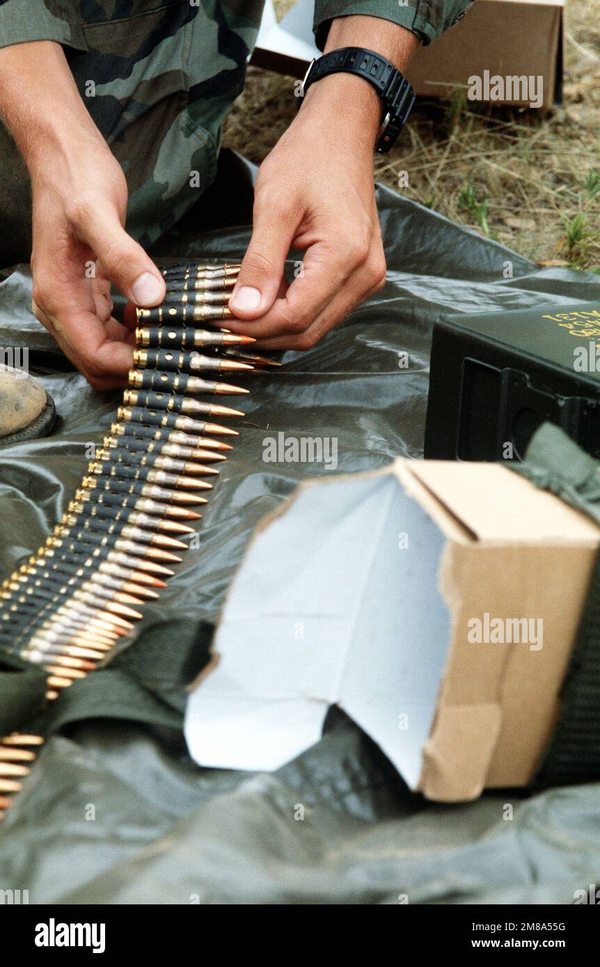 A member of a team competing in the DEFENDER CHALLENGE '88 M60 machine gun event prepares a belt of 7.62 mm ammunition. Subject Operation/Series: DEFENDER CHALLENGE '88 Base: Little Rock Air Force Base State: Arkansas (AR) Country: United States Of America (USA) Stock Photo