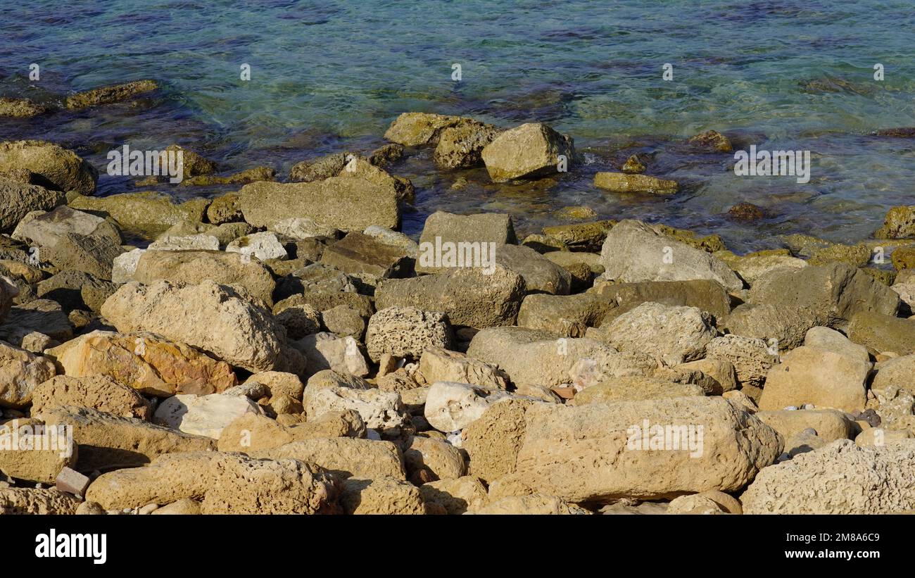Cobble Sized Rocks Cobble pieces of marble rock near water edge in Caesarea Maritima ...