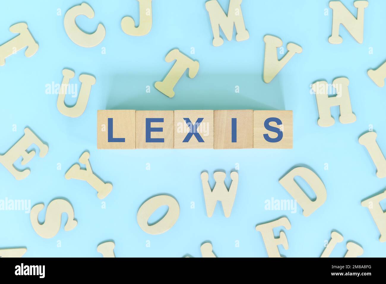 Study lexis in linguistics concept. Wooden blocks word typography flat lay in blue background. Stock Photo